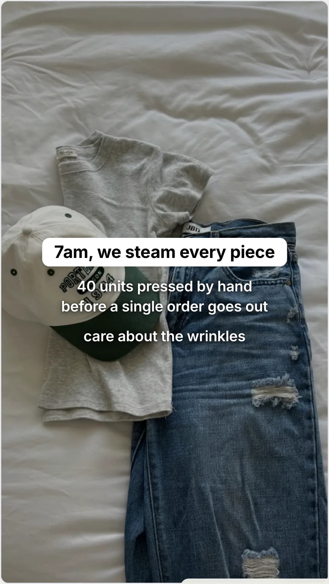 Drop day inside a small fashion studio: slide 2, 7am, we steam every piece. 40 units pressed by hand before a